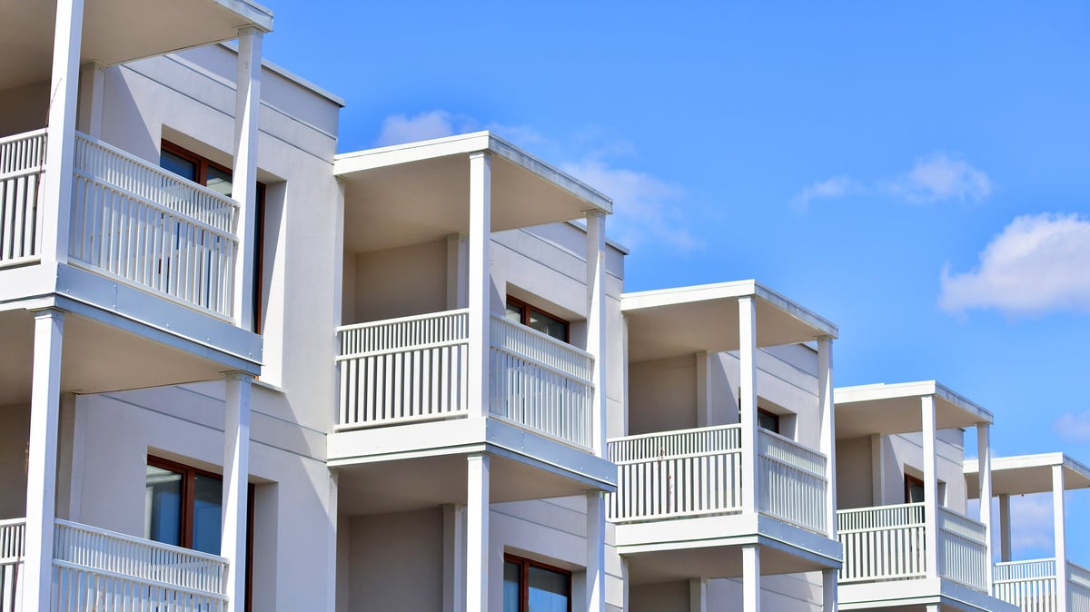 Exterior of modern multi-story residential apartment building with windows and balconies